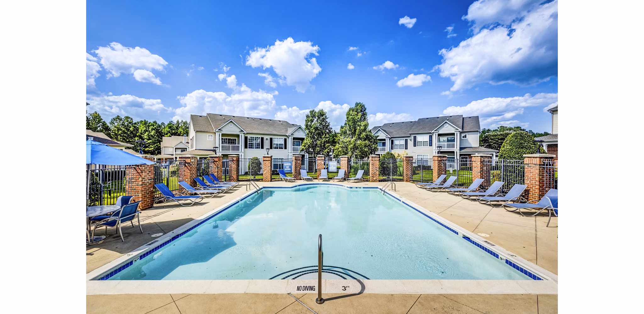 Resort-style pool with lounge chairs at Avana on Broad Apartments