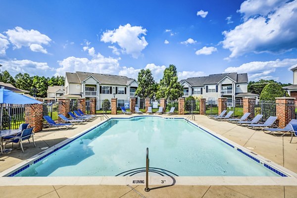 Resort-style pool with lounge chairs at Avana on Broad Apartments
