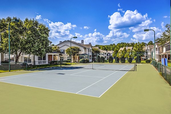 Tennis court with lush surroundings at Avana on Broad Apartments