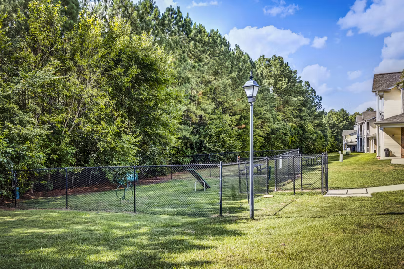 Fenced dog park with agility equipment at Avana on Broad Apartments, perfect for pet-friendly outdoor activities