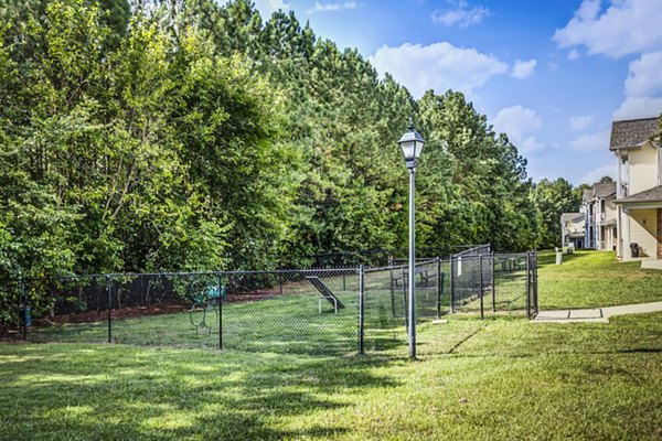 Fenced dog park with agility equipment at Avana on Broad Apartments, perfect for pet-friendly outdoor activities