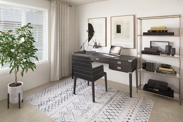 Home office with ergonomic chair and ample natural light in Veri at Timberhill Apartments