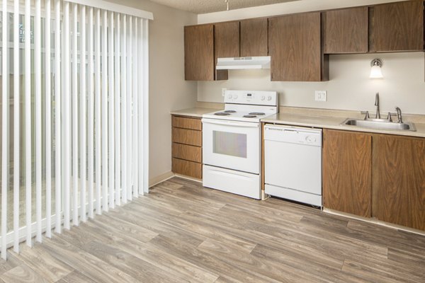 Modern kitchen with stainless steel appliances and sleek countertops at Veri at Timberhill Apartments