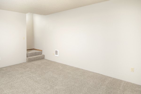 Living room with modern decor and plush seating at Veri at Timberhill Apartments