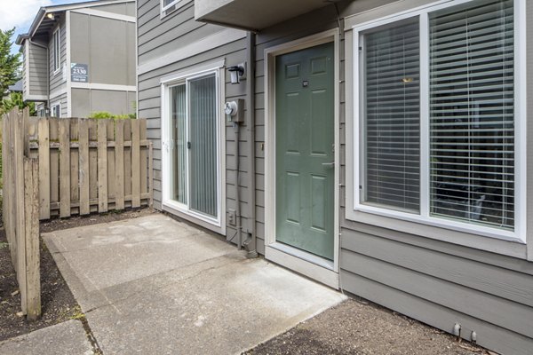 Spacious patio with seating and greenery at Veri at Timberhill Apartments for relaxation and outdoor dining
