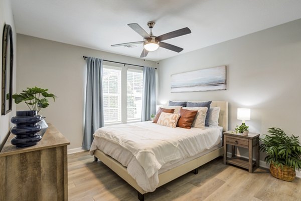 Spacious bedroom with plush carpeting at Avana Overlook Apartments