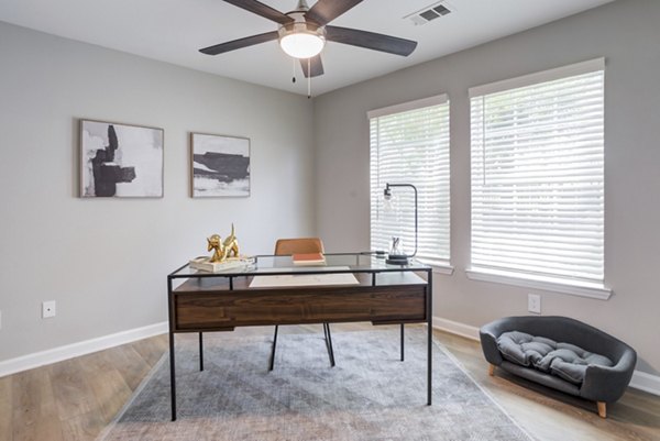 Home office with sleek desk and ergonomic chair in Avana Overlook Apartments, ideal for remote work or study in style