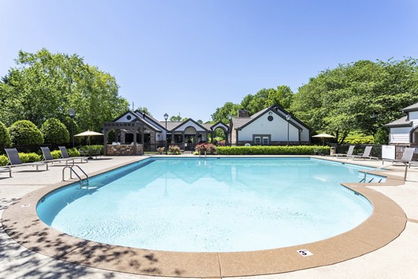 Outdoor pool with lounge chairs at Avana Overlook Apartments, ideal for luxury relaxation and recreation