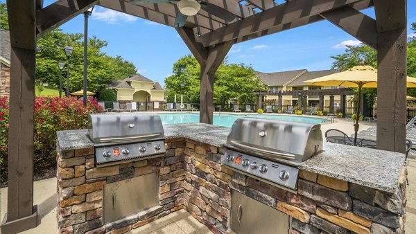 Grill area with stylish seating, perfect for outdoor dining at Avana Overlook Apartments