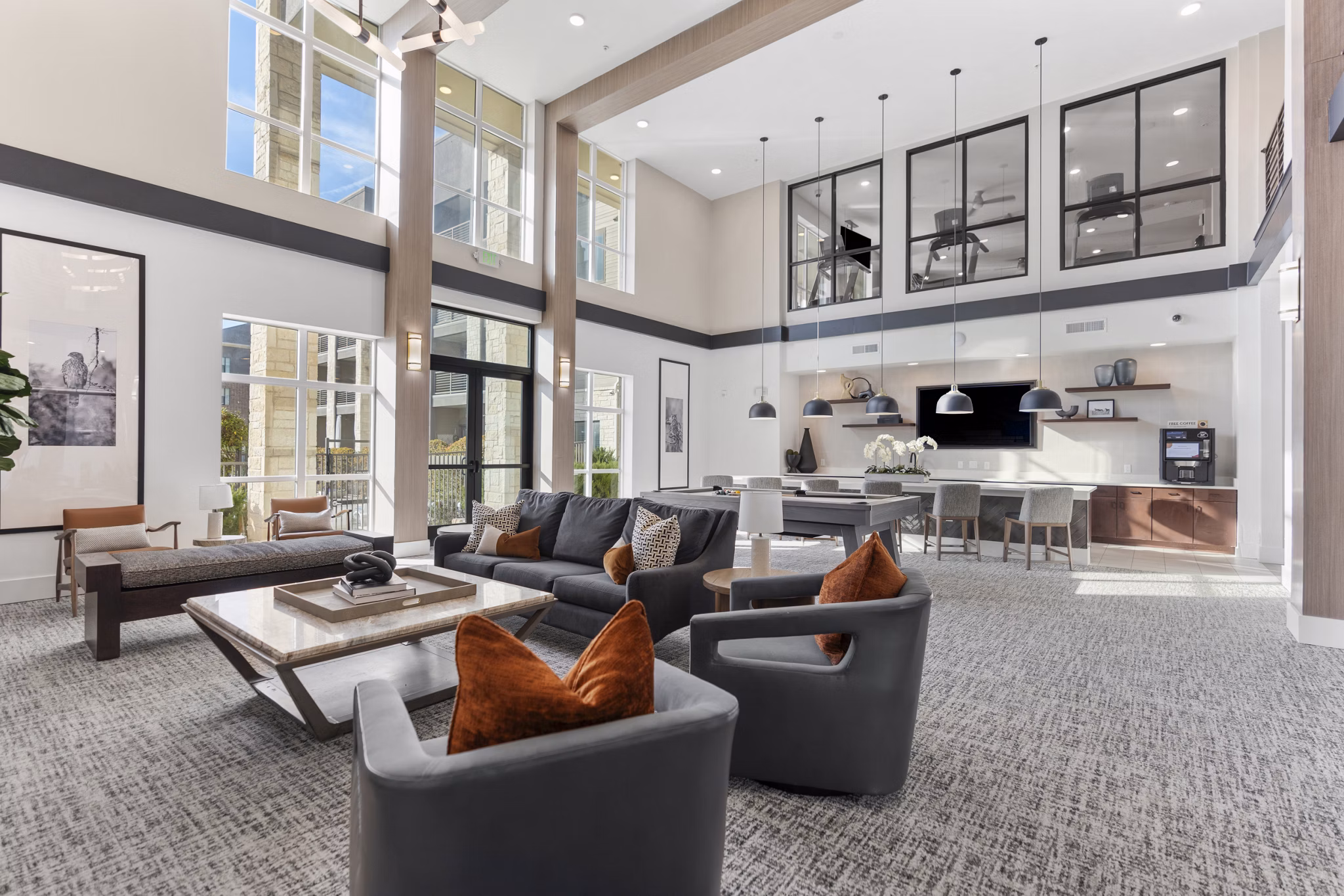 Clubhouse with modern seating and fireplace at The Reflection at Montgomery Ridge apartments