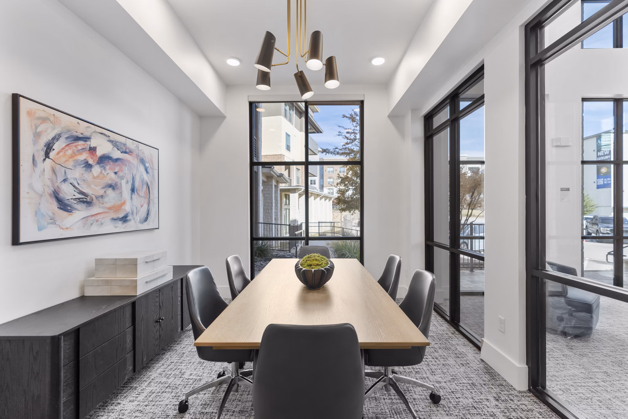 Meeting facility with modern seating and multimedia setup at The Reflection at Montgomery Ridge Apartments