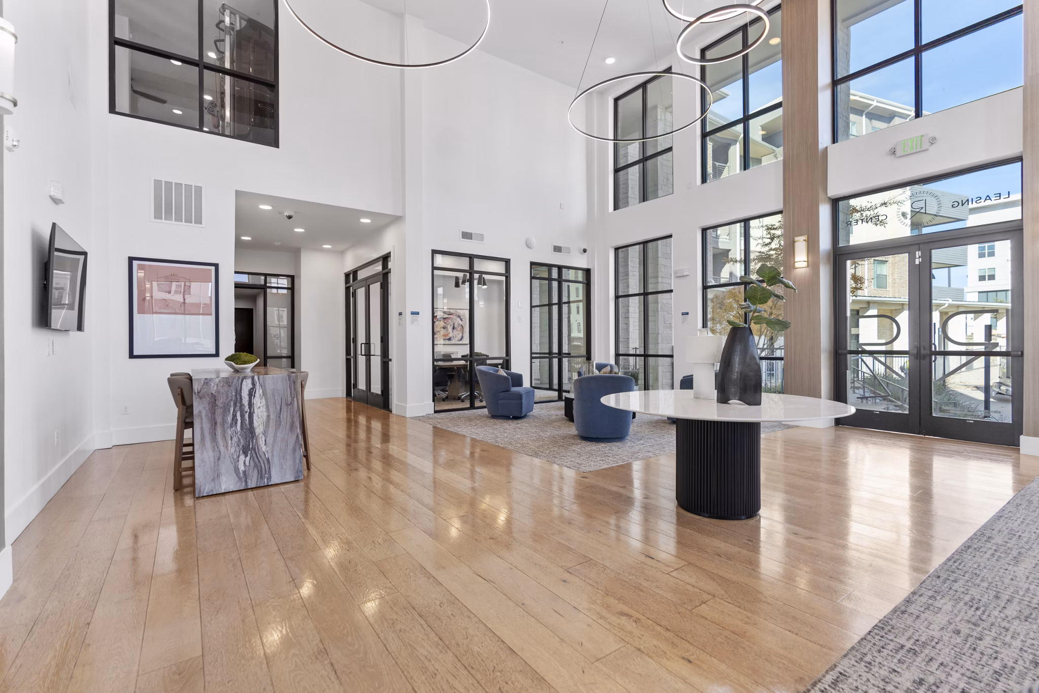 The Reflection at Montgomery Ridge Apartments: Modern clubhouse with elegant furnishings and ample natural light