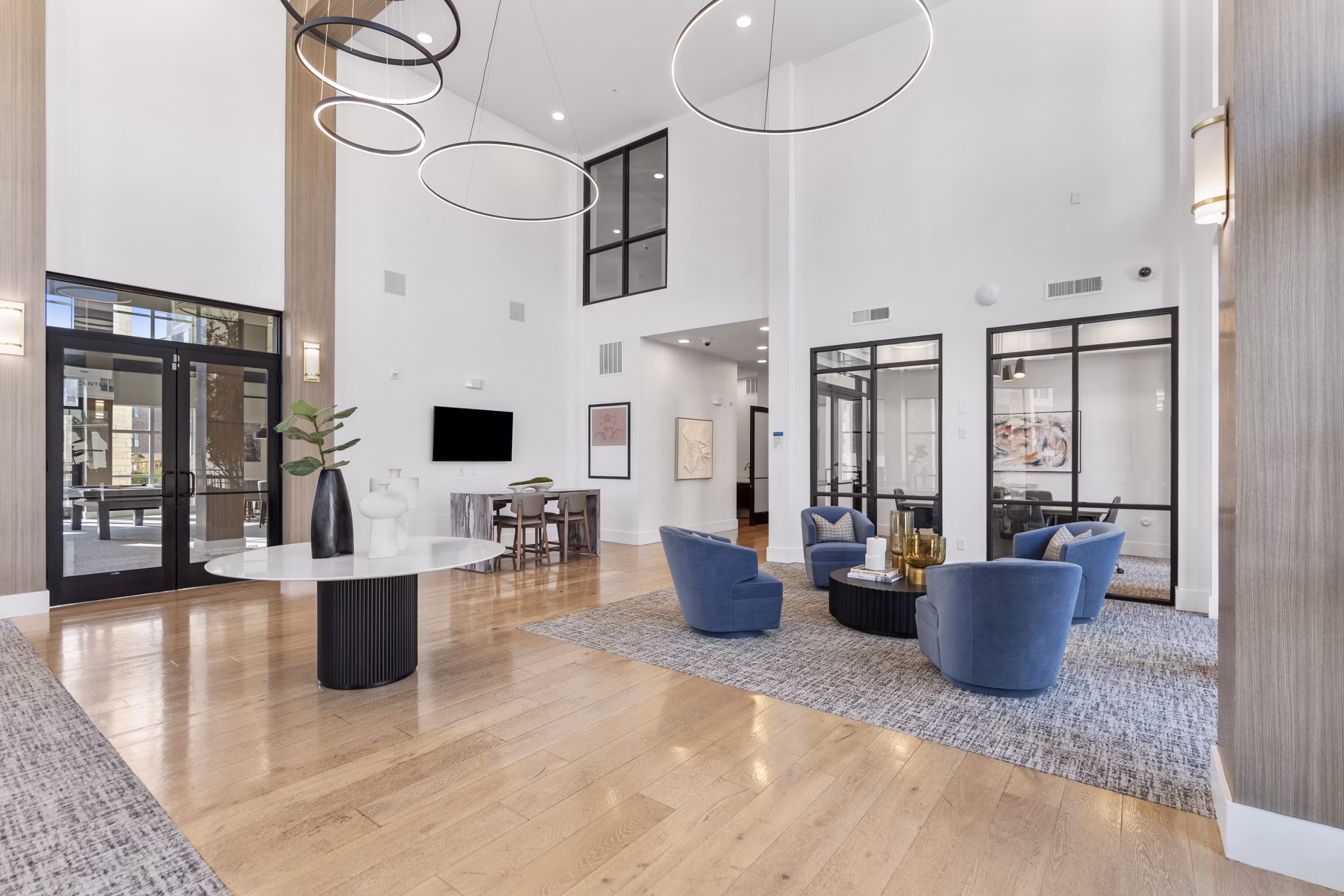 Modern clubhouse with cozy seating areas at The Reflection at Montgomery Ridge Apartments