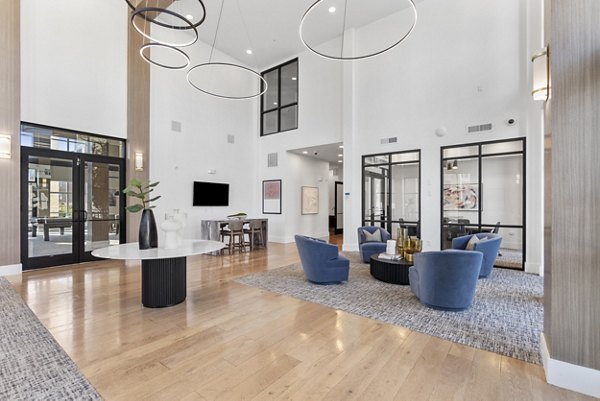 Modern clubhouse with cozy seating areas at The Reflection at Montgomery Ridge Apartments