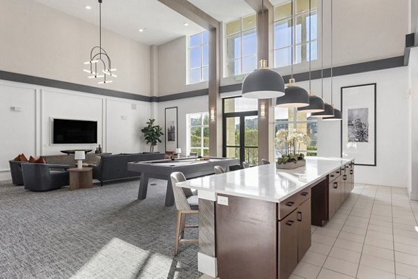 Clubhouse at The Reflection at Montgomery Ridge Apartments: Modern luxury space with communal seating and billiards for residents' enjoyment
