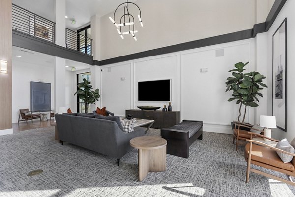 Elegant clubhouse with modern seating and game tables at The Reflection at Montgomery Ridge Apartments