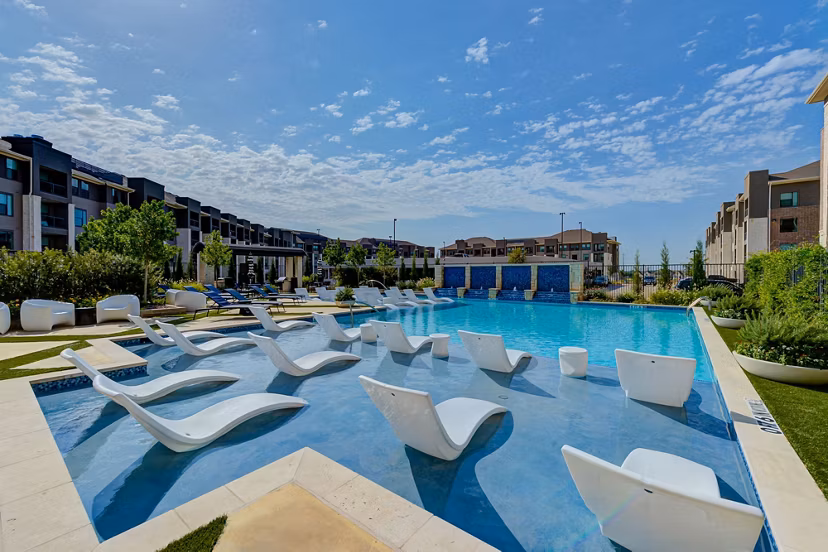 Resort-style pool with sun loungers at The Reflection at Montgomery Ridge luxury apartments