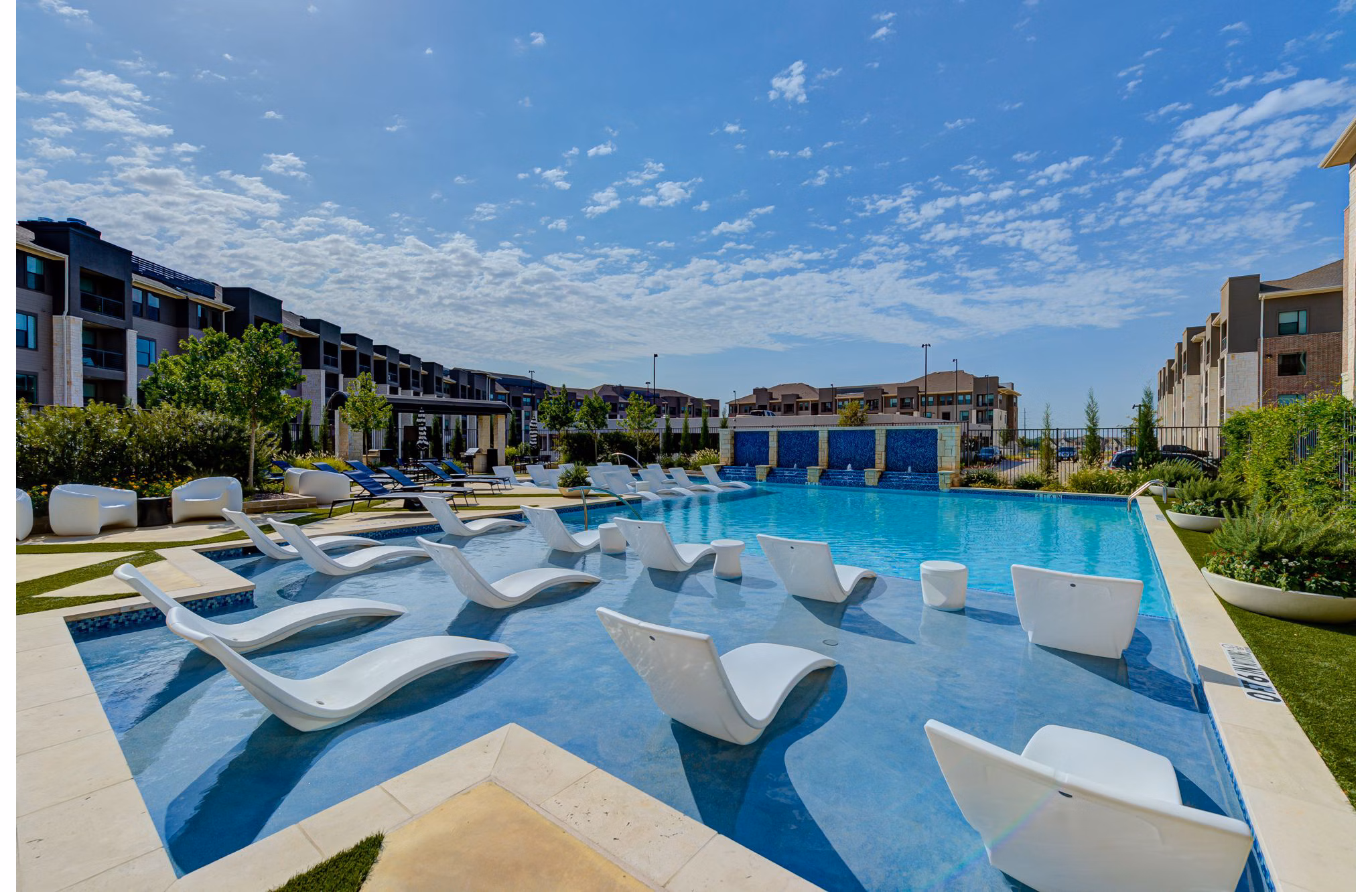 Resort-style pool with sun loungers at The Reflection at Montgomery Ridge luxury apartments