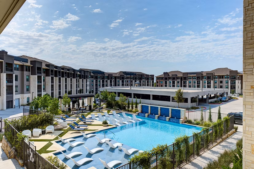 Reflection at Montgomery Ridge: Resort-style pool with lounge chairs in luxury apartments near  training facilities