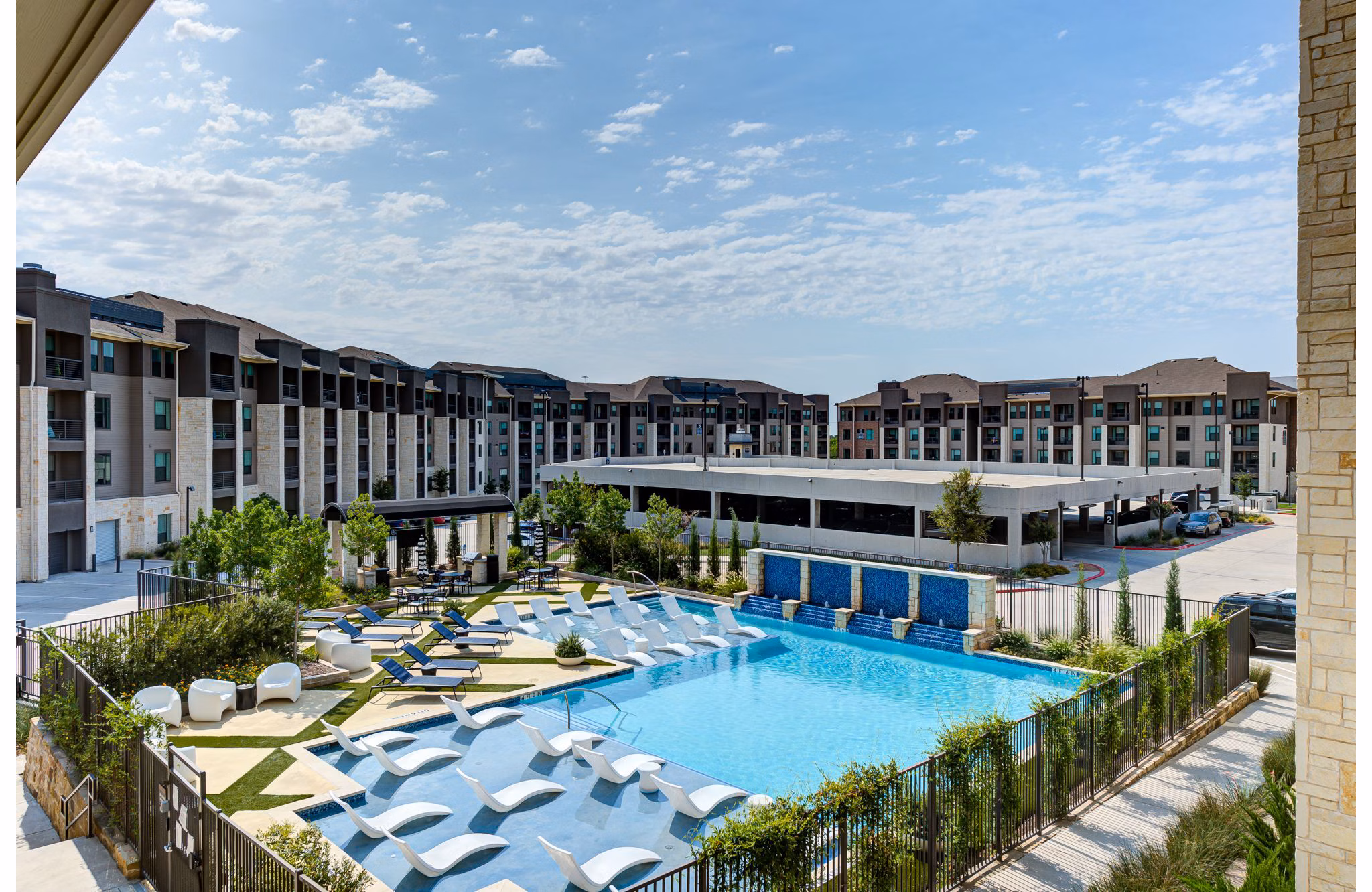 Reflection at Montgomery Ridge: Resort-style pool with lounge chairs in luxury apartments near  training facilities