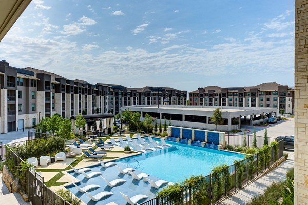 Reflection at Montgomery Ridge: Resort-style pool with lounge chairs in luxury apartments near  training facilities