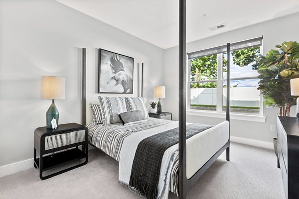 Cozy bedroom with modern decor and plush bedding at Canter Green Apartments, luxury living in a serene environment