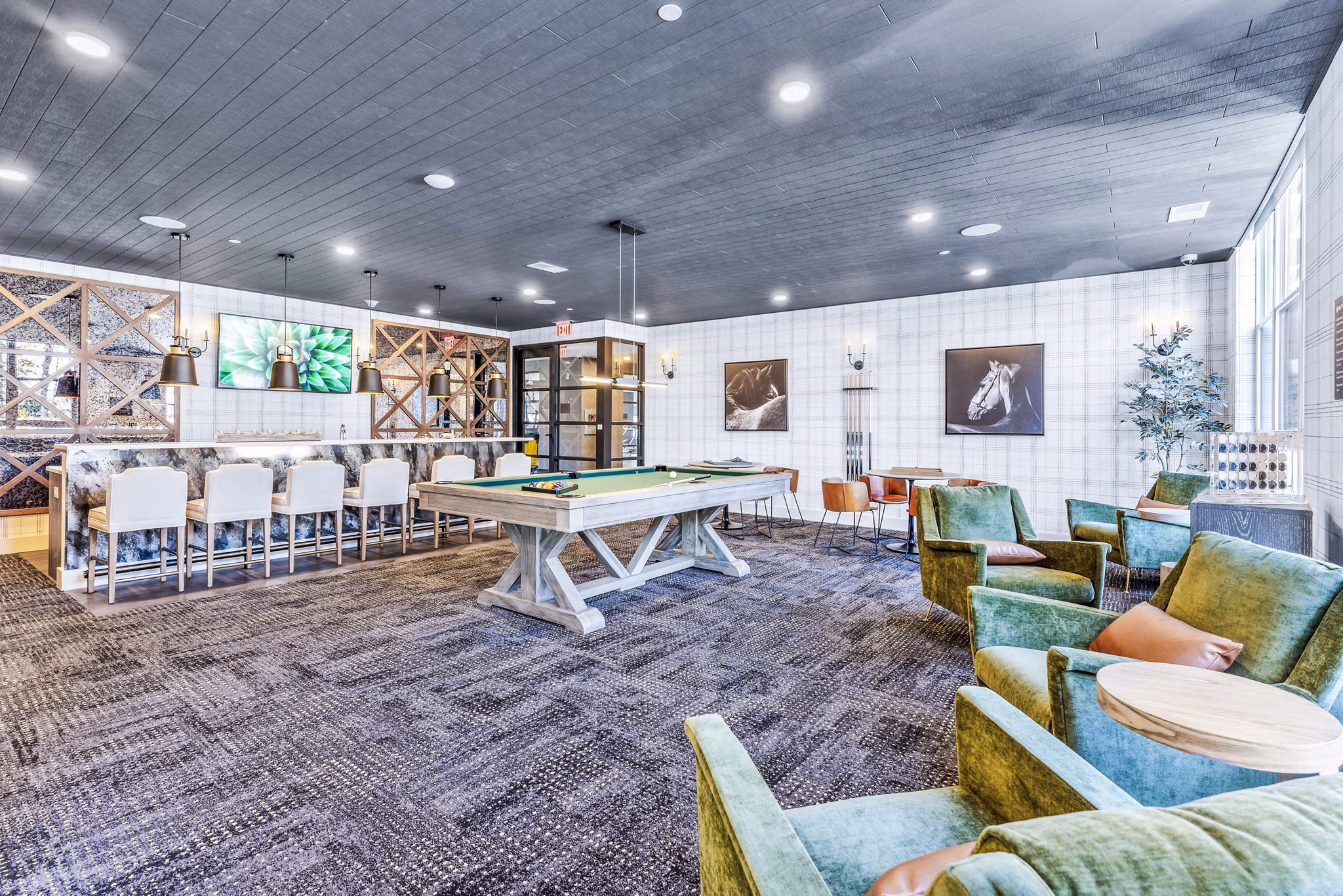 Clubhouse featuring modern design and cozy seating at Canter Green Apartments