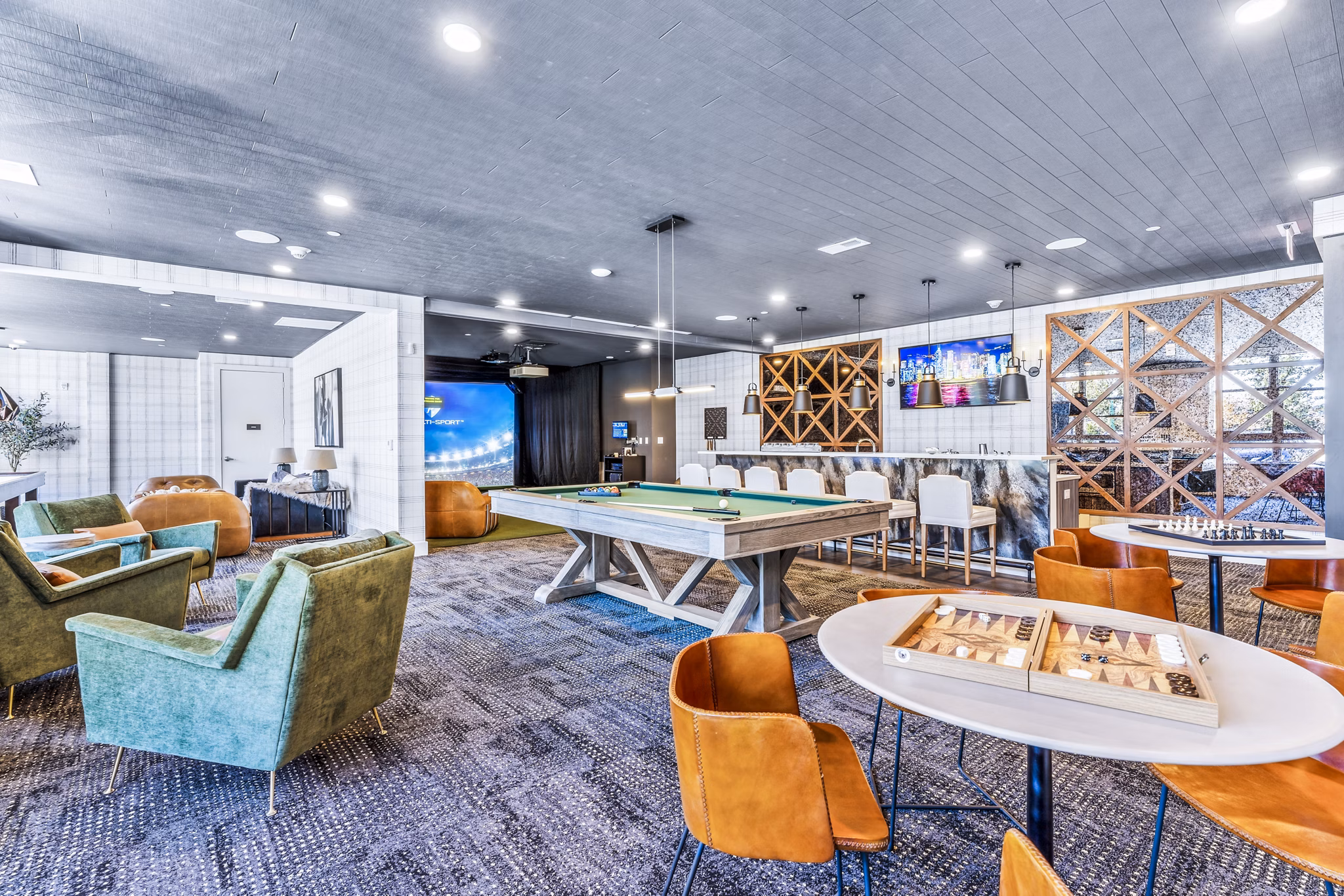 Modern game room with pool table and lounge seating at Canter Green Apartments