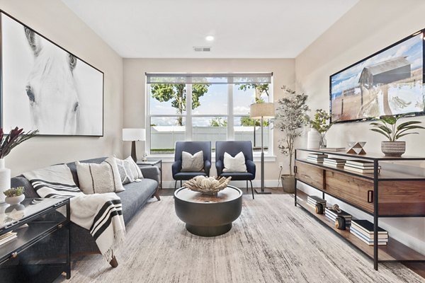 Spacious living room boasting modern decor and ample natural light in Canter Green Apartments
