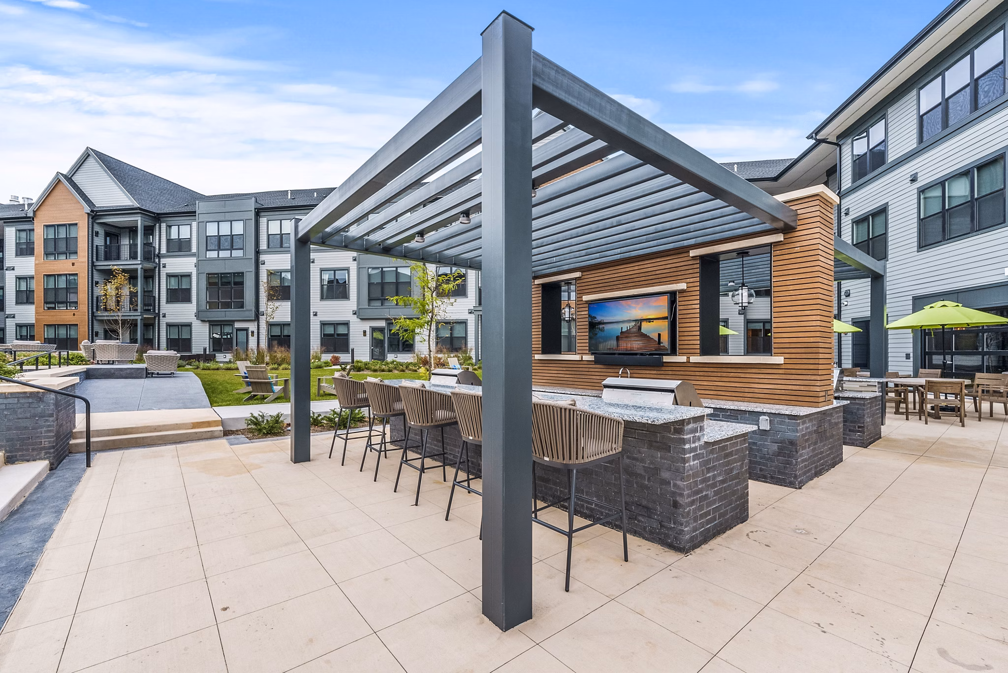 Grill area patio with modern seating at Canter Green Apartments, luxury living spaces ideal for social gatherings