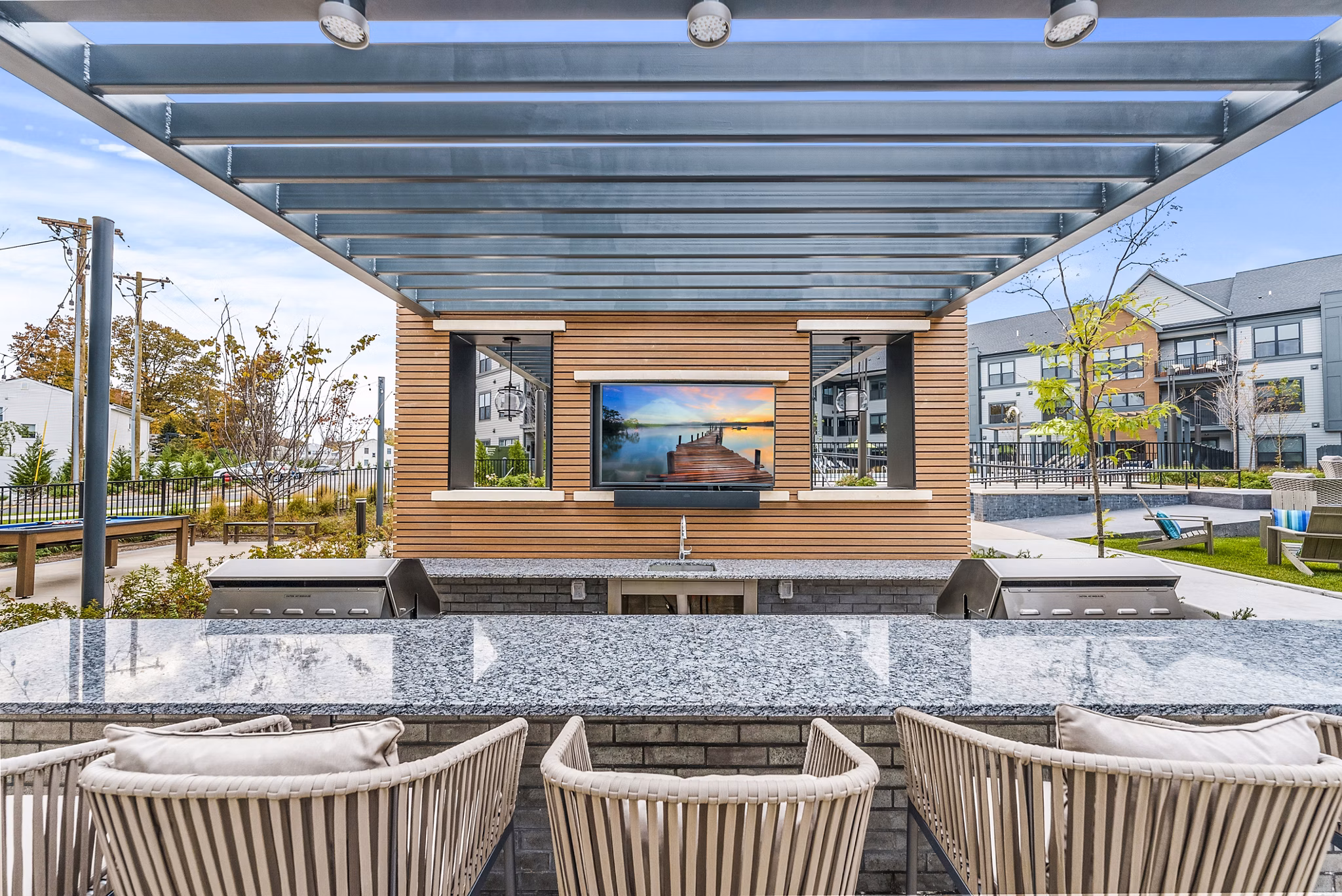 Outdoor grill area at Canter Green Apartments: Spacious patio in a luxury apartment community ideal for gatherings and entertaining