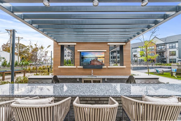 Outdoor grill area at Canter Green Apartments: Spacious patio in a luxury apartment community ideal for gatherings and entertaining