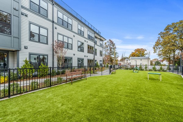 Spacious dog park with agility equipment at Canter Green Apartments, perfect for pet-friendly living