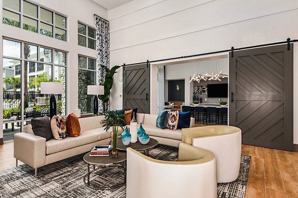 Modern clubhouse with stylish seating and decor at Encore Metro at Millenia Apartments, perfect for social gatherings and events