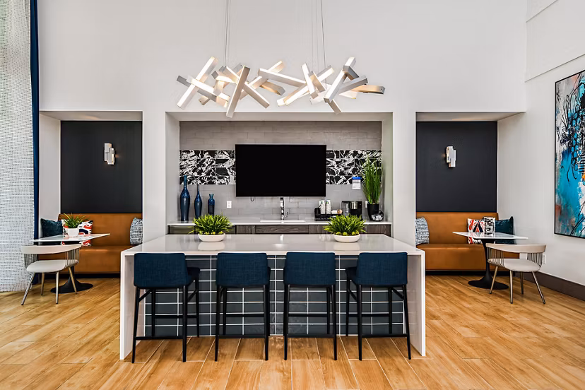Elegant clubhouse at Encore Metro at Millenia Apartments with plush seating and modern decor, perfect for relaxation and social gatherings
