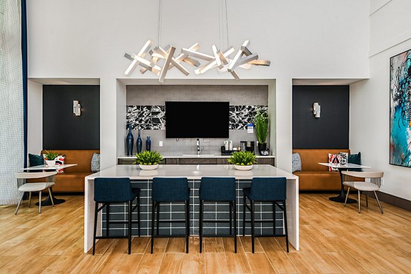 Elegant clubhouse at Encore Metro at Millenia Apartments with plush seating and modern decor, perfect for relaxation and social gatherings