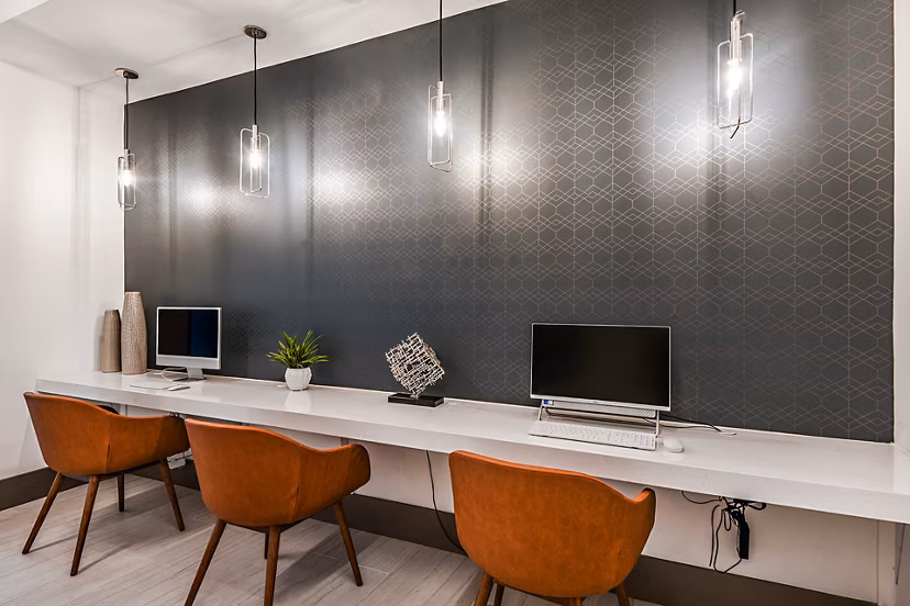 Clubhouse business center with modern workstations at Encore Metro at Millenia Apartments