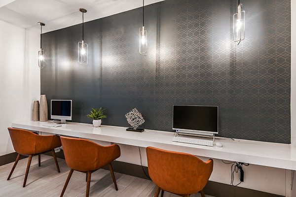 Clubhouse business center with modern workstations at Encore Metro at Millenia Apartments