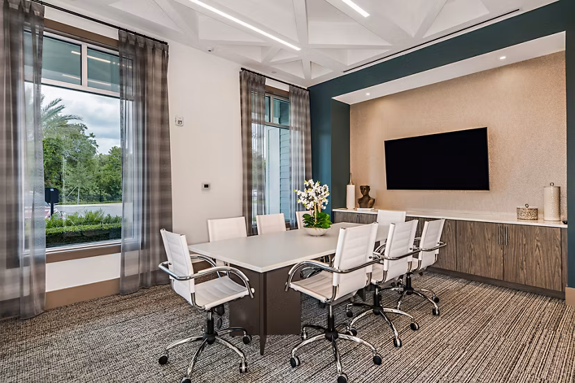 Spacious clubhouse meeting facility featuring modern decor at Encore Metro at Millenia Apartments, ideal for gatherings and events