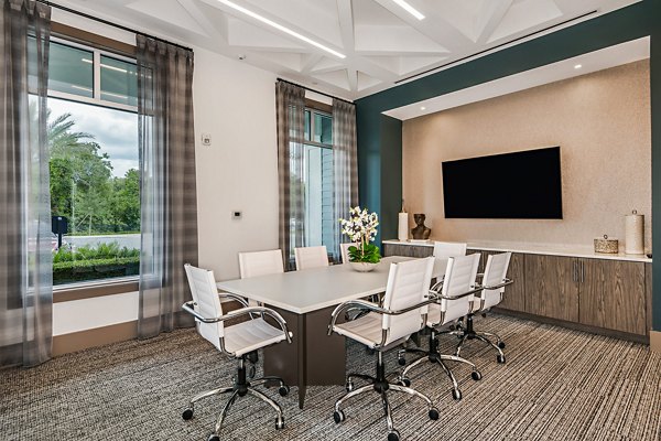 Spacious clubhouse meeting facility featuring modern decor at Encore Metro at Millenia Apartments, ideal for gatherings and events