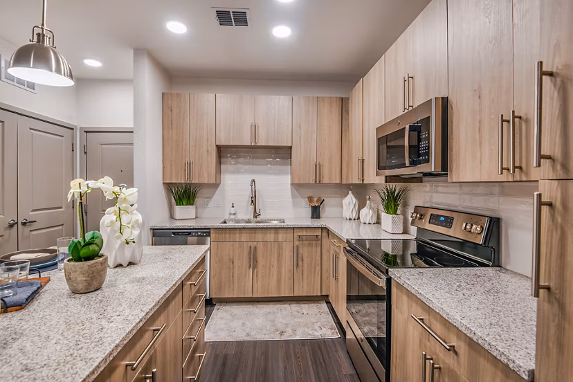 Modern kitchen with stainless steel appliances at Encore Metro at Millenia Apartments