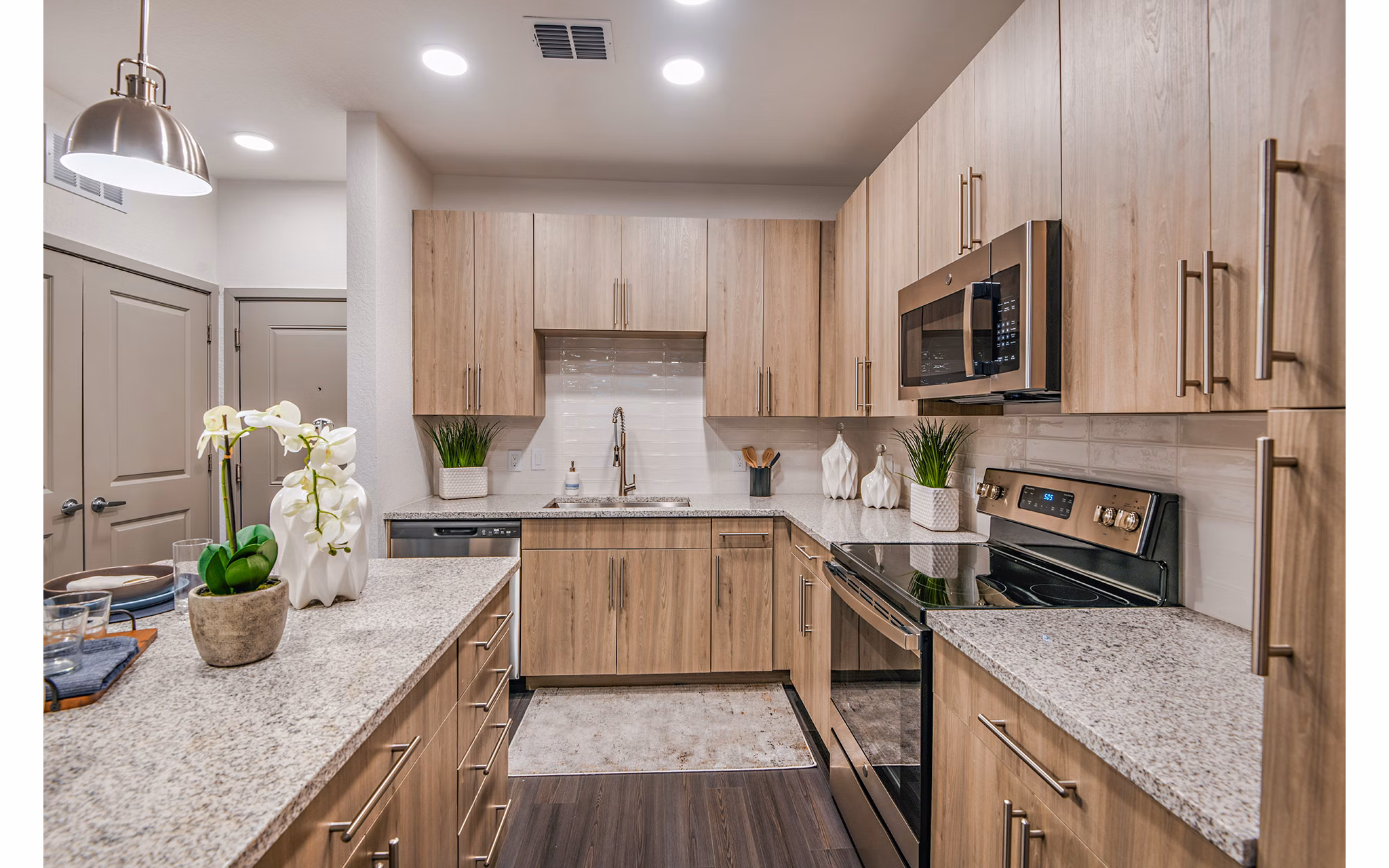 Modern kitchen with stainless steel appliances at Encore Metro at Millenia Apartments