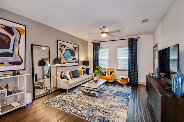 Spacious living room with modern decor at Encore Metro at Millenia Apartments