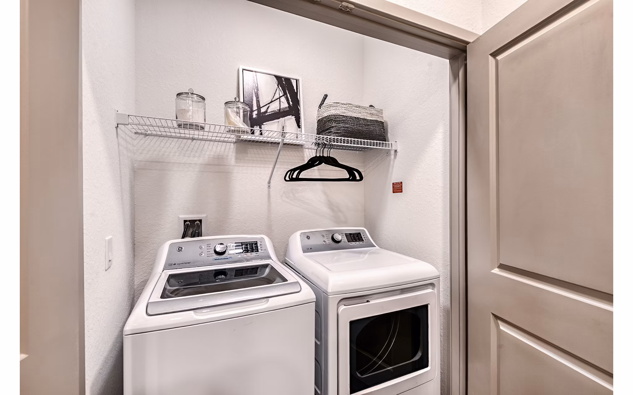 Laundry room featuring modern washers and dryers at Encore Metro at Millenia Apartments