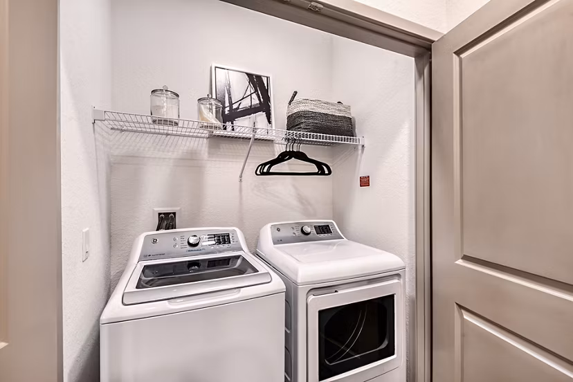 Laundry room featuring modern washers and dryers at Encore Metro at Millenia Apartments