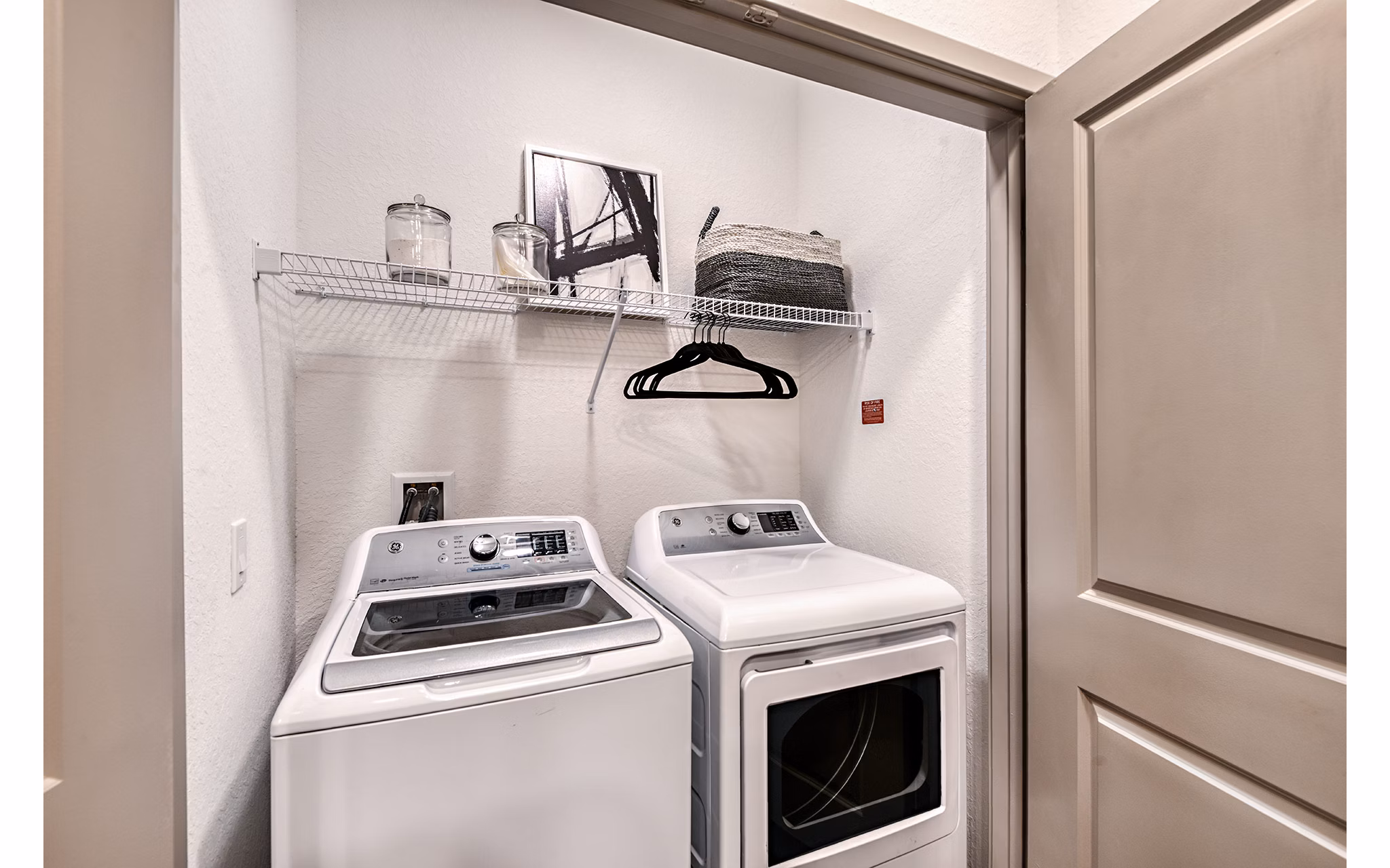 Laundry room featuring modern washers and dryers at Encore Metro at Millenia Apartments