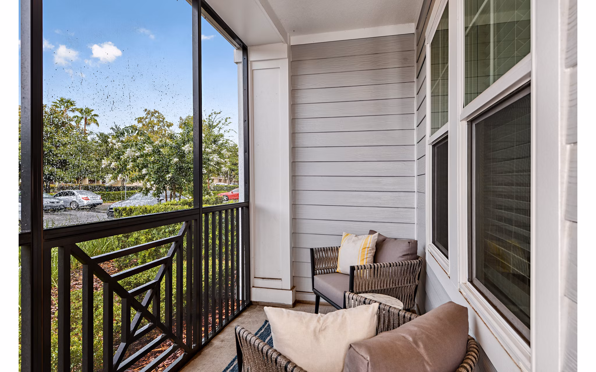 Spacious balcony with modern seating at Encore Metro at Millenia Apartments, offering luxury city views