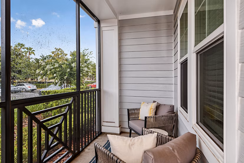 Spacious balcony with modern seating at Encore Metro at Millenia Apartments, offering luxury city views