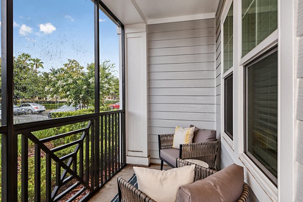 Spacious balcony with modern seating at Encore Metro at Millenia Apartments, offering luxury city views