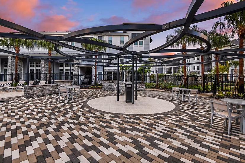 Stylish outdoor patio with cozy seating at Encore Metro at Millenia Apartments, ideal for relaxation and social gatherings